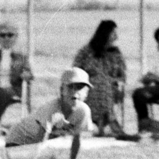 Baseball player sliding into base.