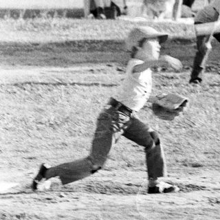 Baseball player sliding into base.