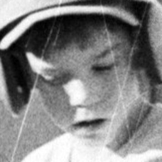 Two boys playing tee-ball in 1970s-style attire.