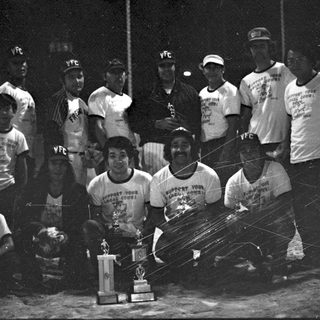 Victorious youth baseball team with championship trophy.