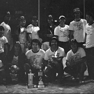 Victory team photo with championship trophy.