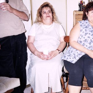 Group of four people indoors, seated casually.