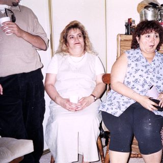 Group of four people indoors, seated casually.