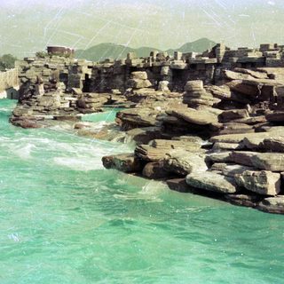 Dam with rocky breakwater and water flow.