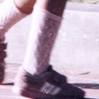 Two children playing frisbee outdoors.