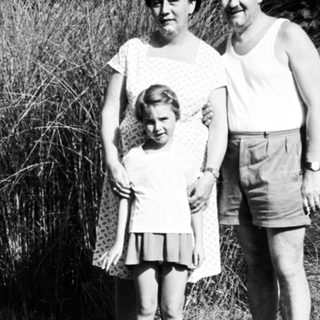 Family portrait outdoors in vintage clothing.