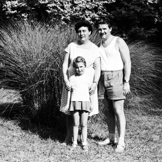 Family portrait outdoors in vintage clothing.