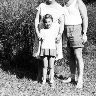 Family portrait outdoors in vintage clothing.