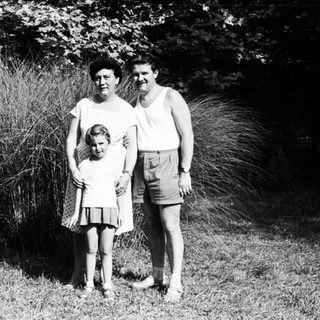 Family portrait outdoors in vintage clothing.
