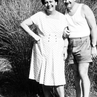 Two people posing together outdoors in summer attire.