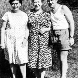 Three people posing outdoors in summer attire, 1950s-60s.
