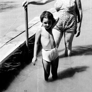 Family enjoying beach with shallow water.
