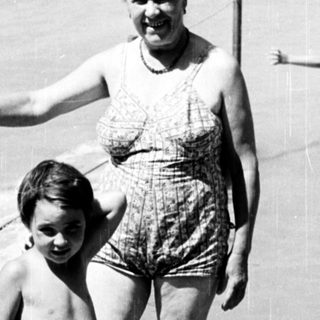 Family enjoying beach with shallow water.