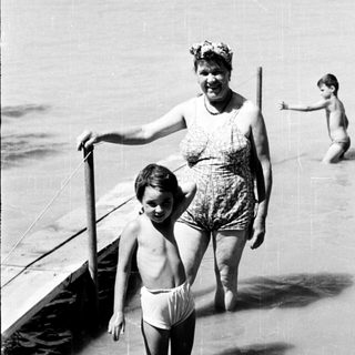 Family enjoying beach with shallow water.