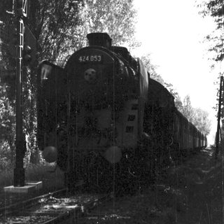 Steam locomotive numbered 444 053 on railway tracks.