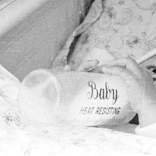 Baby sleeping in heat-resistant bassinet.