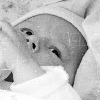 Baby sleeping in heat-resistant bassinet.