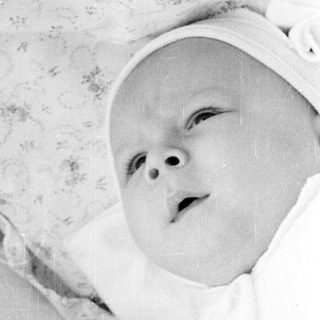 Infant lying in a crib.