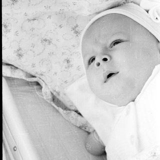 Infant lying in a crib.