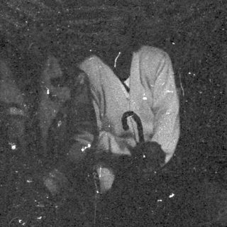 People skiing in low-light or night conditions.