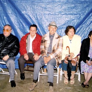 Group of six people posing indoors at an event.