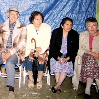 Group of six people posing indoors at an event.
