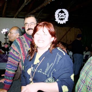 Group of people laughing indoors at event.