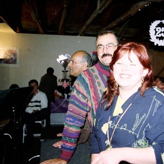 Group of people laughing indoors at event.