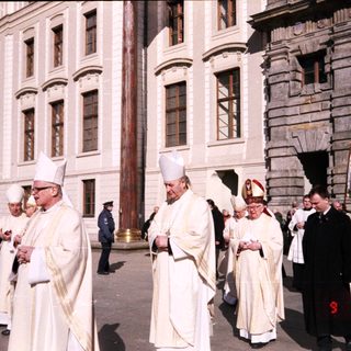Religious procession with clergy in liturgical vestments.
