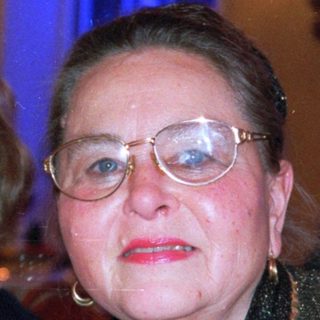 Elegant woman in evening attire at formal event.
