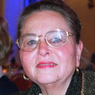 Elegant woman in evening attire at formal event.