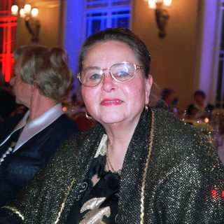 Elegant woman in evening attire at formal event.