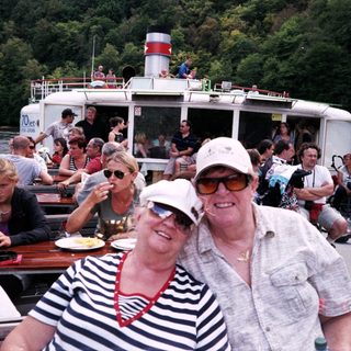 Boat tour with happy passengers enjoying river cruise.