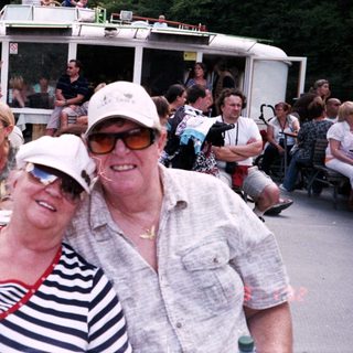 Boat tour with happy passengers enjoying river cruise.