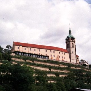 Historic castle on hill by river.
