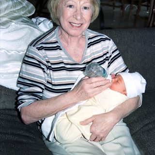 Woman holding newborn baby indoors.
