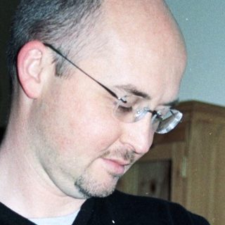 Man holding baby during bottle feeding.