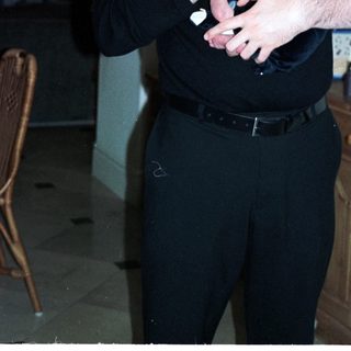 Man holding newborn baby indoors.