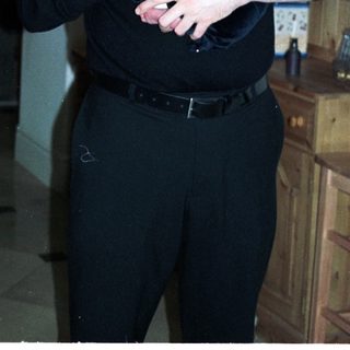 Man holding newborn baby indoors.