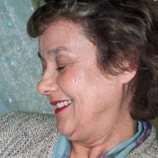 A woman holding a newborn baby indoors.