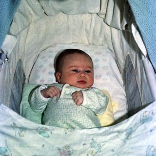 Baby in a portable bassinet or travel crib.