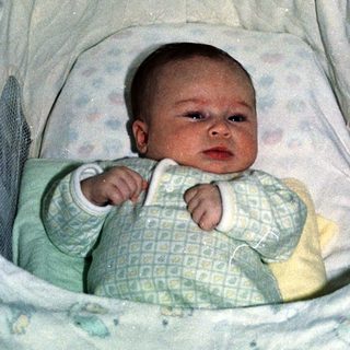 Baby in a portable bassinet or travel crib.