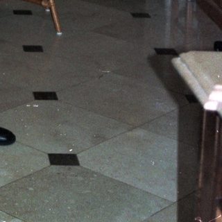 Man holding baby in formal dining room.