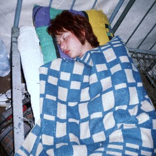 Person sleeping peacefully in hospital bed.