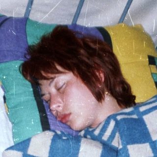 Person sleeping peacefully in hospital bed.