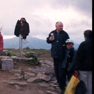 Group hiking summit celebration with flagpole.