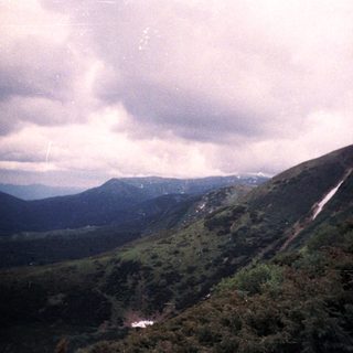 Misty mountain valley with rolling hills.