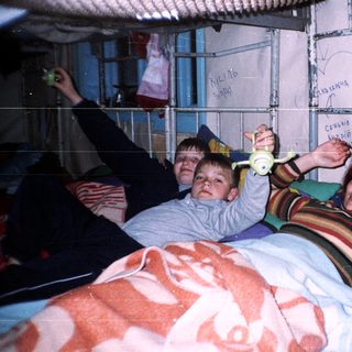 Family playing with hula hoops indoors.