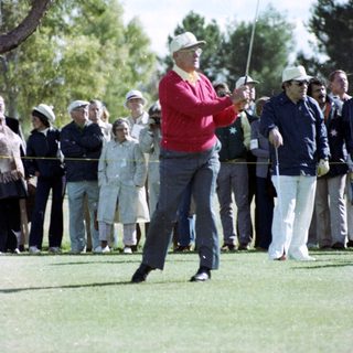 Golfer mid-swing during a public round.