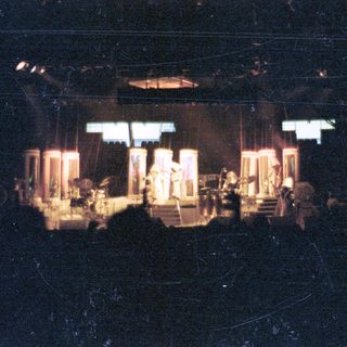 Live band performing on stage at night.